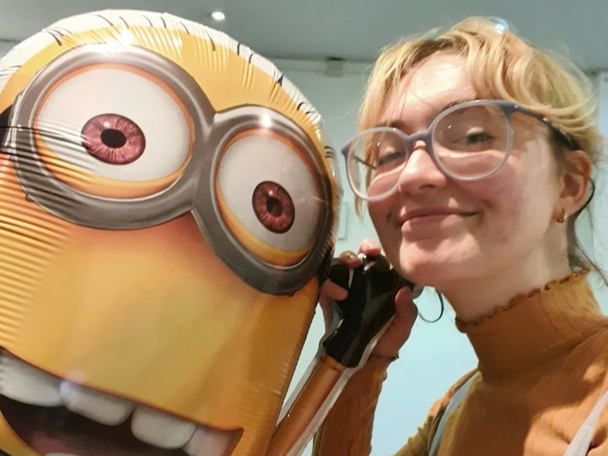 Amy Cresswell taking a selfie with a Minion balloon.