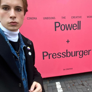 J Taylor Jones against a poster of the Powell + Pressburger season at the BFI Southbank